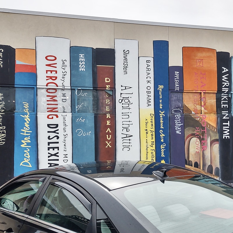 painting of books stacked vertically